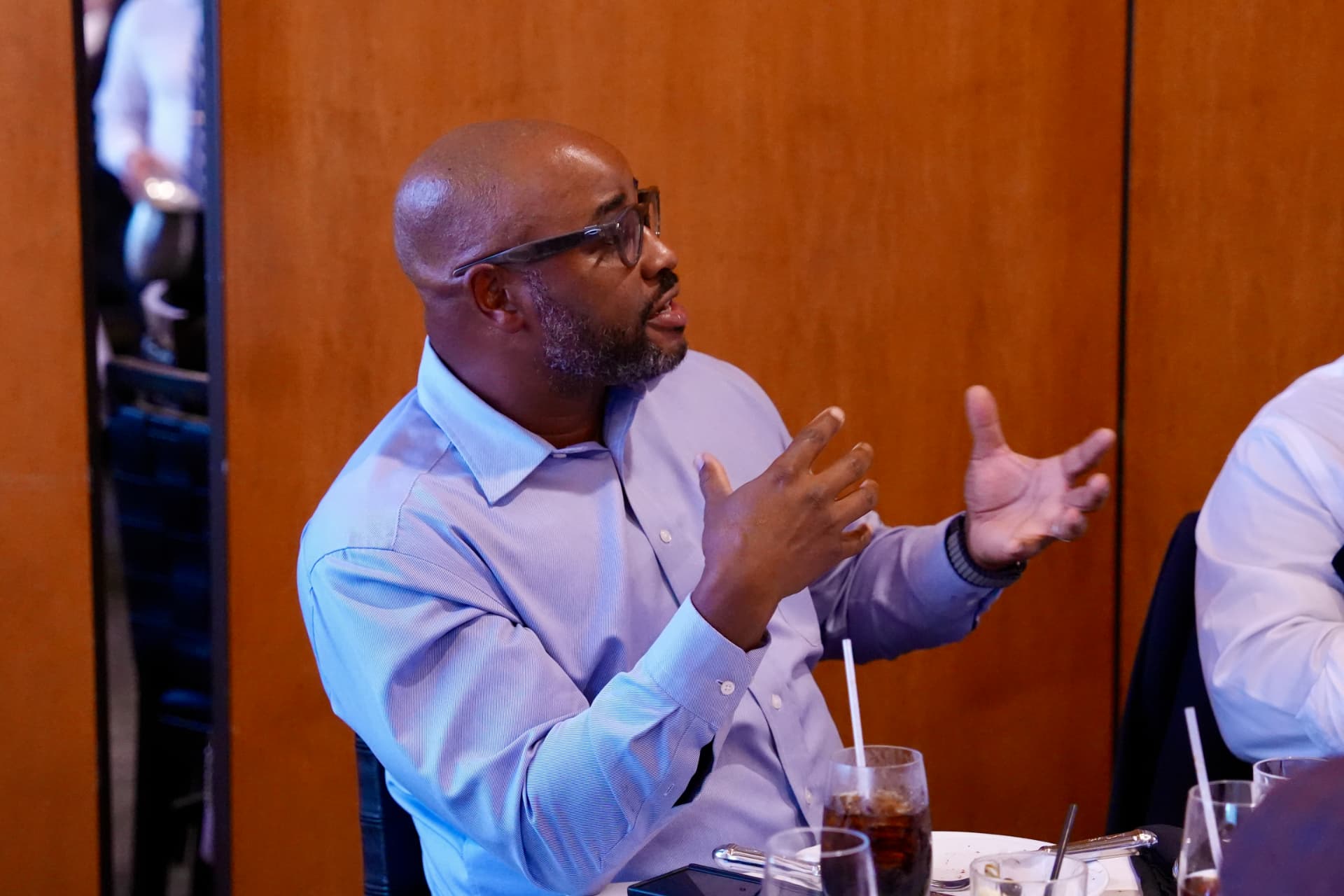 Guests in conversation over dinner at a Cyber In Color event